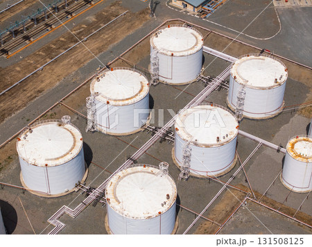 Seven white storage tanks at industrial site during daytime 131508125