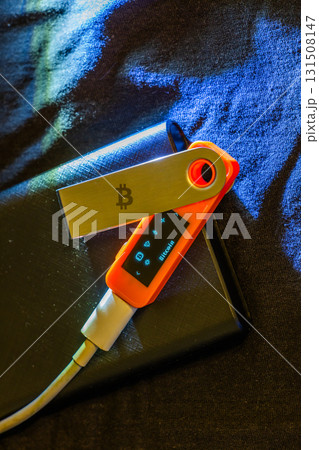 Orange cold storage hardware wallet with Bitcoin logo and screen Orange cold storage hardware wallet with Bitcoin logo and screen 131508147