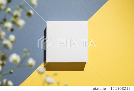 White cube, podium or box with shadow on diagonally divided yellow and blue background White cube, podium or box with shadow on diagonally divided yellow and blue background 131508215