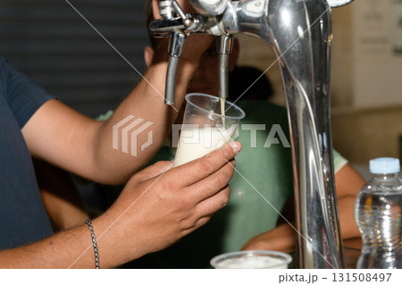 barman hand at beer tap pouring a draught lager beer serving in a restaurant or pub barman hand at beer tap pouring a draught lager beer serving in a restaurant or pub 131508497