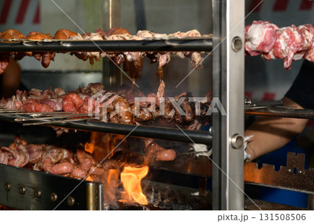 Grilling Assorted Meats at a Vibrant Barbecue Event Outdoors 131508506