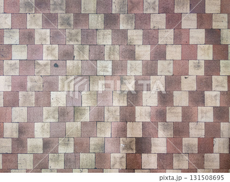 Worn checkerboard soviet tile floor in factory locker room 131508695