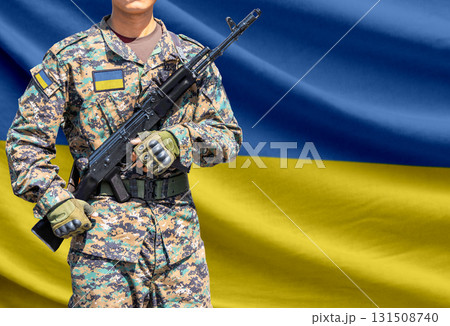 Ukraine flag with soldier holding assault rifle 131508740
