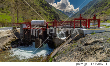 Water Control Structure Flowing in Serene Mountainous Region 131508791
