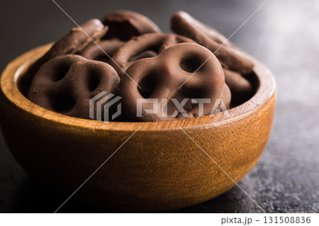 Chocolate covered pretzels on black table. 131508836
