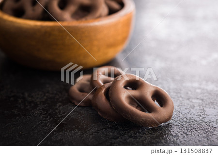 Chocolate covered pretzels on black table. 131508837