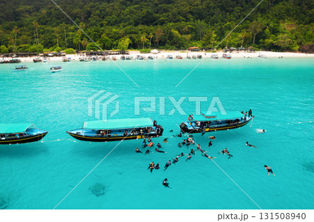 Top view of parked Boats and tourists in the sea near turtle beach on Redang Island in Malaysia 131508940