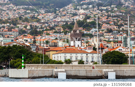 Funchal, Madeira, Portugal. A vibrant harborfront cityscape features a stone church 131509168