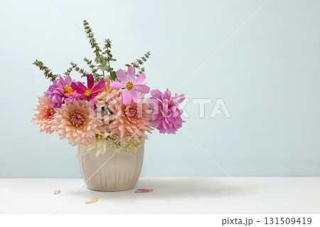 Beautiful dahlia flowers in a vase, abstract floral arrangement, autumn background with place for text, minimal holiday concept, still life, postcard. Happy birthday greetings, wedding Beautiful dahlia flowers in a vase, abstract floral arrangement, autumn background with place for text, minimal holiday concept, still life, postcard. Happy birthday greetings, wedding 131509419