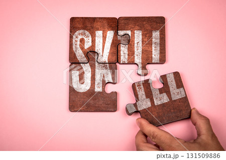 Skill Concept. Hand placing last wooden puzzle piece on pink background 131509886