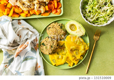 Enjoy a vibrant breakfast featuring scrambled eggs with rhubarb, fluffy quinoa pancakes, creamy avocado drizzled with olive oil, roasted vegetables, and a refreshing fresh salad 131510009