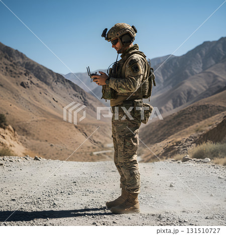 Soldier Operating a Remote Drone Controller in a Desert Valley Soldier Operating a Remote Drone Controller in a Desert Valley 131510727