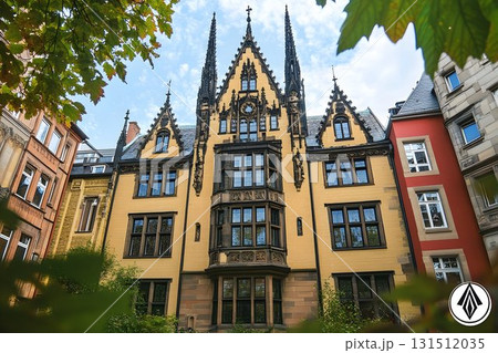 Ornate Yellow Building with Gothic Architecture and Leafy Framin 131512035