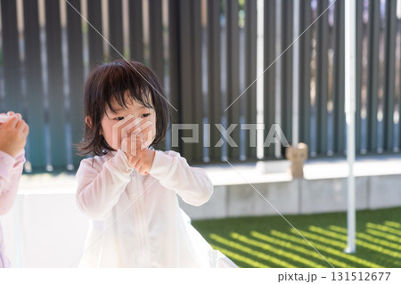 自宅のプールで遊ぶ女の子の幼児 自宅のプールで遊ぶ女の子の幼児 131512677