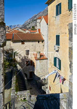 View Over Terracotta Roofs and Stone Houses Towards Rocky Mountains in a Mediterranean Old Town View Over Terracotta Roofs and Stone Houses Towards Rocky Mountains in a Mediterranean Old Town 131512839