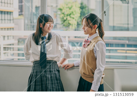 窓際でお喋りする女子中学生たち 131513059