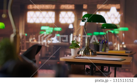 Professional library space designed with historic architecture and study desks, vintage aesthetics offering sophisticated and peaceful environment for research and academic endeavors. Refined space. 131513152