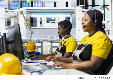 Black female plant worker offering guidance in troubleshooting errors at solar facility call center, managing help line requests for support and maintenance. Customer service operator. Black female plant worker offering guidance in troubleshooting errors at solar facility call center, managing help line requests for support and maintenance. Customer service operator. 131513332