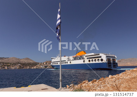 Ferry arriving at Symi port in Greece 131514737