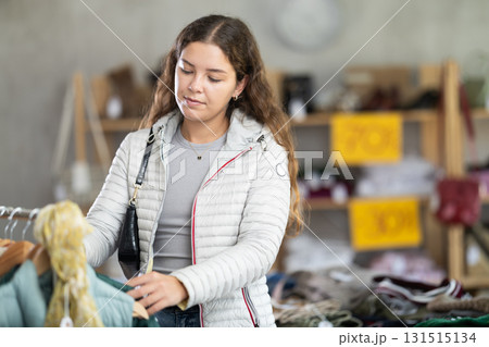 During November sales, young woman choose and buy something autumn outwear 131515134