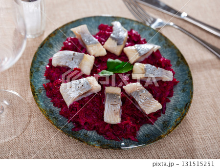Lightly salted herring with beets served on platter 131515251