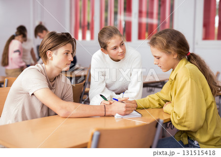Fellow students having group work tasks during school class Fellow students having group work tasks during school class 131515418