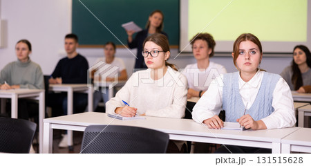 Young girls students study diligently at school Young girls students study diligently at school 131515628