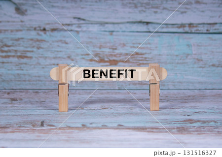 Benefit symbol. Single Wooden stick squeezed by Clothespins, Grungy blue Wooden Texture Background. Business and Benefit concept with copy space 131516327