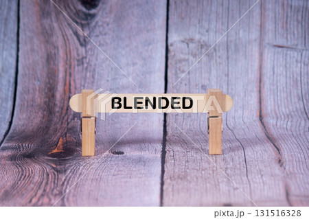 Blended symbol. Single Wooden stick supported by Clothespins, beautiful Light Orange tone highlight Wooden Texture Background. Business and Blended concept with copy space Blended symbol. Single Wooden stick supported by Clothespins, beautiful Light Orange tone highlight Wooden Texture Background. Business and Blended concept with copy space 131516328