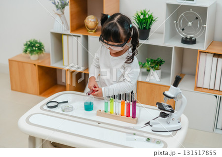 toddler girl scientist making chemical test with test tube and beaker. learning science toddler girl scientist making chemical test with test tube and beaker. learning science 131517855