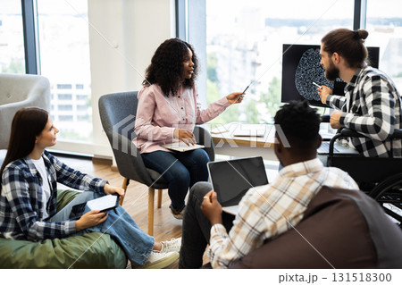 Diverse group of young professionals collaborating on artificial intelligence project in modern workspace. Analysis includes brainstorming and discussion. 131518300