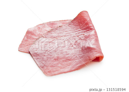 Sliced beef pastrami isolated on white background. Sliced beef pastrami isolated on white background. 131518594
