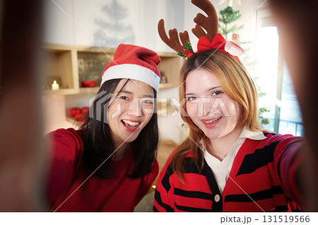 Joyful Christmas Selfie with Friends in Festive Outfits Joyful Christmas Selfie with Friends in Festive Outfits 131519566