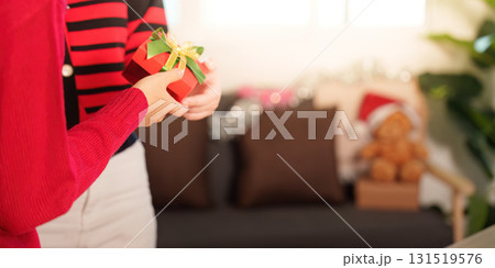 Gift Exchange. Two friends celebrating Christmas with drinks and a beautifully wrapped present. Gift Exchange. Two friends celebrating Christmas with drinks and a beautifully wrapped present. 131519576