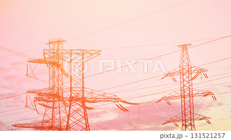 Power lines in the rays of a red sunset represent the concept of electric current transmission through high-voltage wires and the clean energy of electricity. Power lines in the rays of a red sunset represent the concept of electric current transmission through high-voltage wires and the clean energy of electricity. 131521257