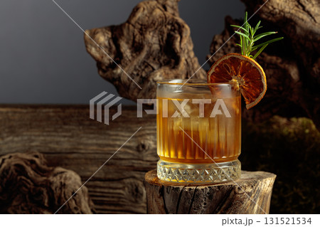 Old-fashioned cocktail with ice on an old wooden stump. Old-fashioned cocktail with ice on an old wooden stump. 131521534