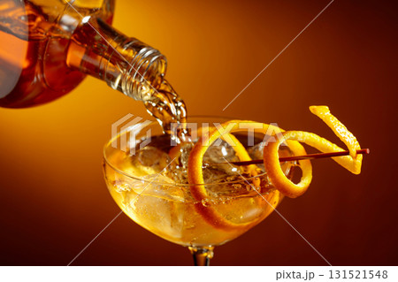Old-fashioned cocktail garnished with orange peel. Old-fashioned cocktail garnished with orange peel. 131521548