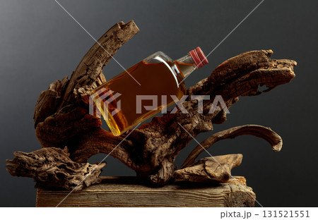 Bottle of whiskey on a old snags. Bottle of whiskey on a old snags. 131521551