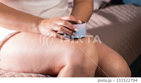 The girl does an anti-cellulite massage on her legs with a portable vacuum massager. Getting rid of flabby skin and cellulite, close-up, effective The girl does an anti-cellulite massage on her legs with a portable vacuum massager. Getting rid of flabby skin and cellulite, close-up, effective 131522794