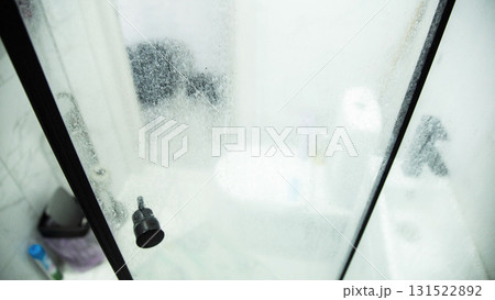 White marks and hard water stains on the transparent shower doors in the bathroom. Unsanitary and Hygiene Cleaning Solution, industry 131522892