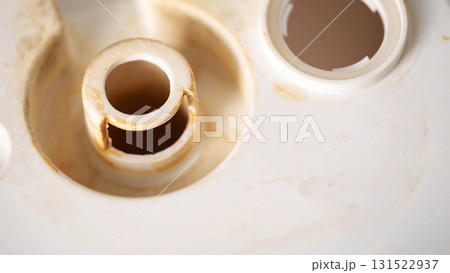 Dirty humidifier from hard water and mold. Hard water and scale, rust in white humidifier, close-up 131522937