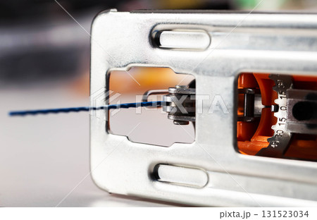 A modern, new electric hand-held jigsaw, close-up. Woodworks A modern, new electric hand-held jigsaw, close-up. Woodworks 131523034