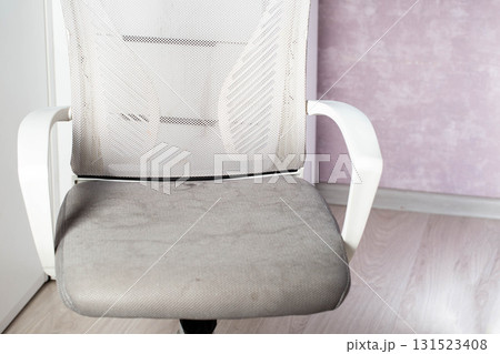 Dirty gray computer chair with stains on upholstery fabric, dry cleaning, close-up 131523408