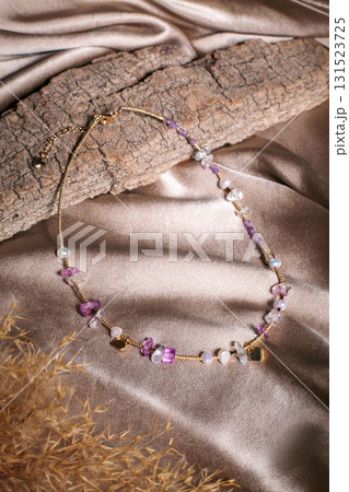 Unique costume jewelry necklace on silk fabric backdrop 131523725