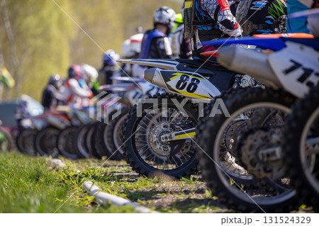View rear wheels of motocross motorcycles standing on starting line 131524329