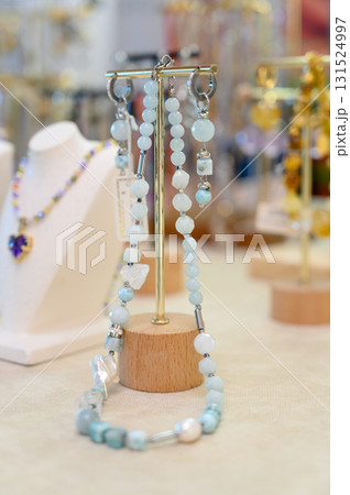A collection of handcrafted earrings on a gold-plated jewelry stand A collection of handcrafted earrings on a gold-plated jewelry stand 131524997