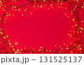 Christmas string lights glowing on red background, festive holiday garland decoration, top view celebration concept 131525137