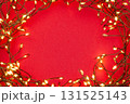Christmas string lights glowing on red background, festive holiday garland decoration, top view celebration concept 131525143