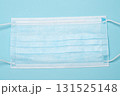 Blue medical mask, top view on blue background, healthcare, safety, and protective face mask concept 131525148