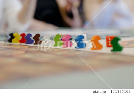 Close-up view of the board game playing field with a row of colorful rabbit chips Close-up view of the board game playing field with a row of colorful rabbit chips 131525162